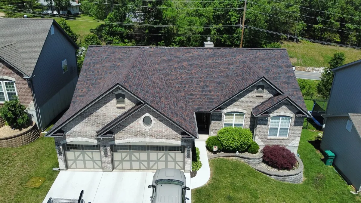 Brick ranch home with a new brown designer-style shingle roof