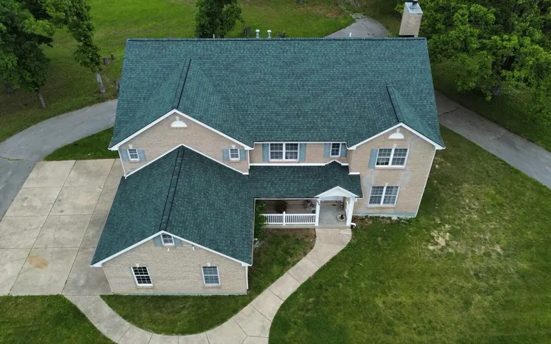 Two-story home with a new deep green shingle roof