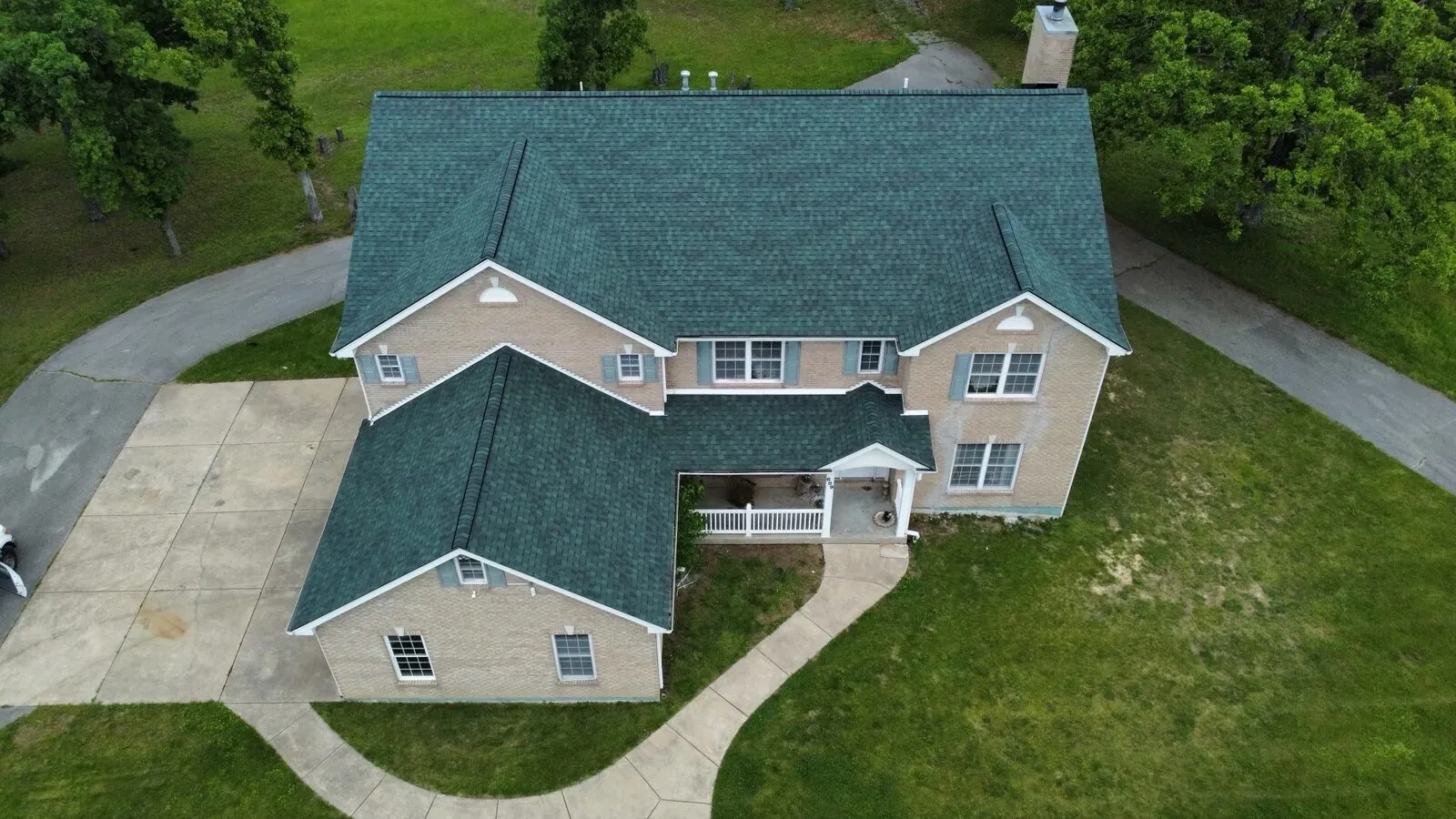 Two-story home with a new deep green shingle roof