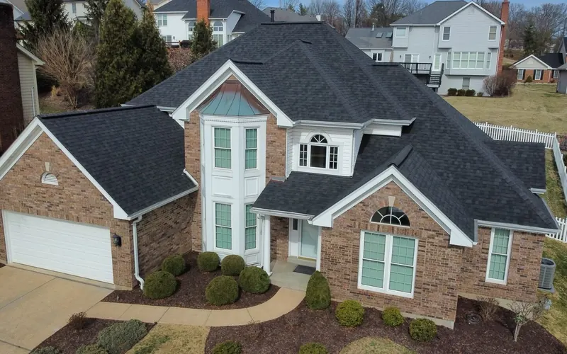 Brick two-story St. Louis home with a new dark architectural shingle roof