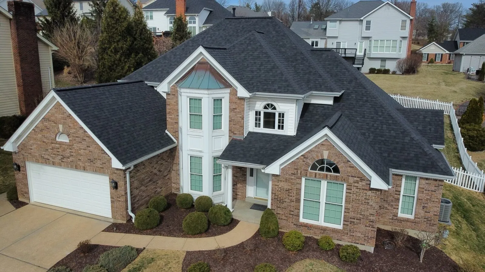 Brick two-story St. Louis home with a new dark architectural shingle roof